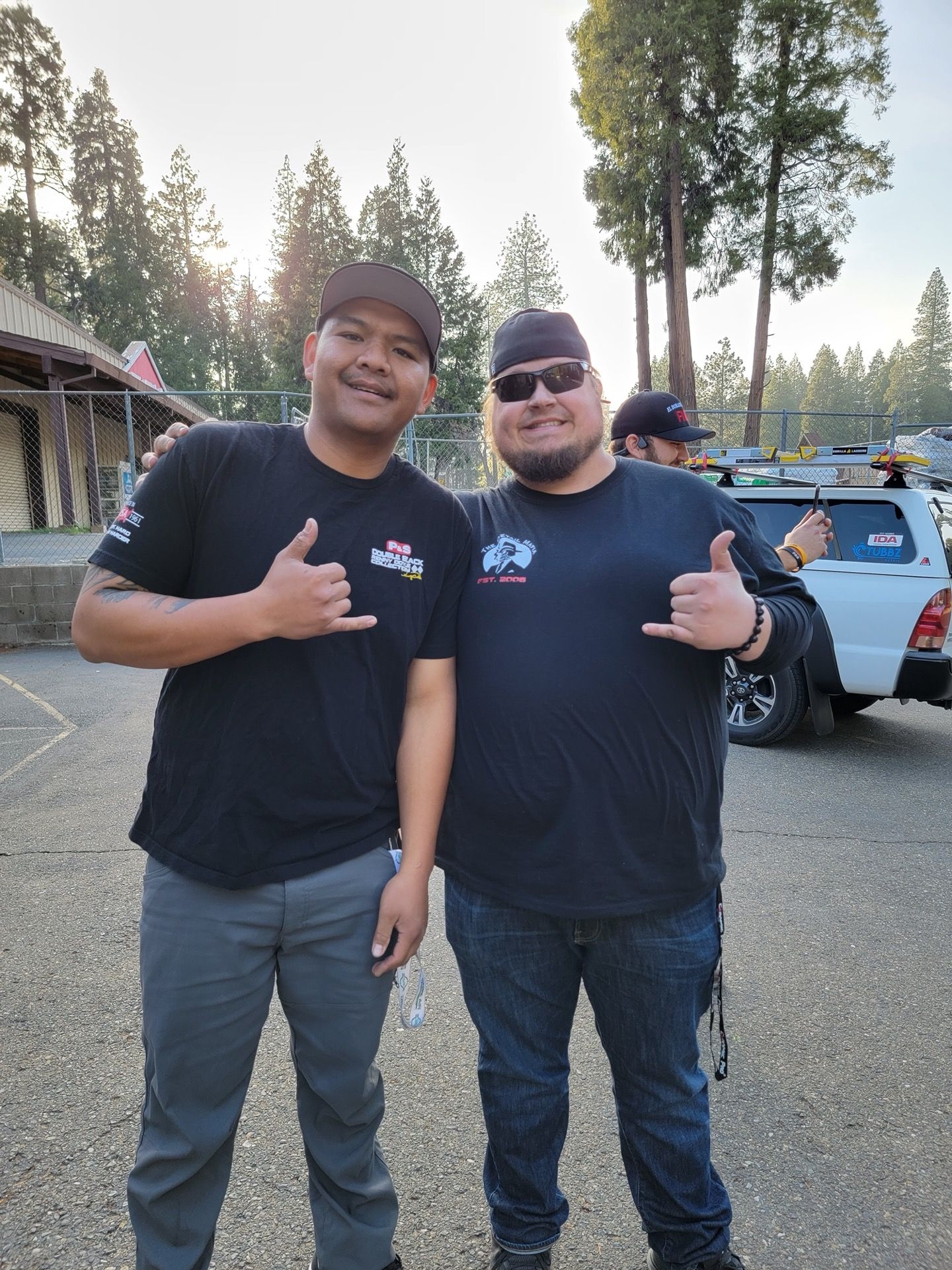 Two men smiling, giving