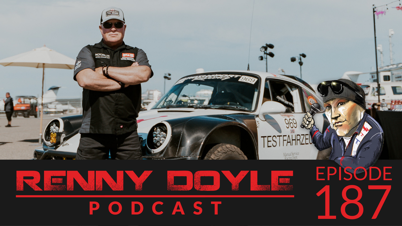 Man standing with arms crossed next to a black and white Porsche race car; podcast episode 187.