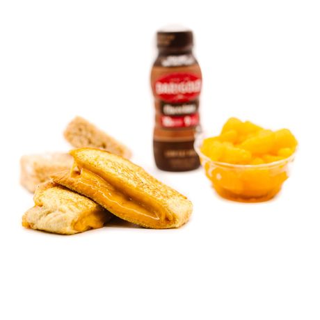 Lunchable meal with grilled cheese, oranges, and chocolate milk.