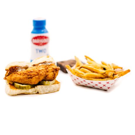 Fried chicken slider with pickles, fries, drink, and brownie.