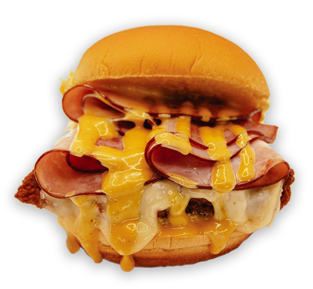 Hamburger bun sandwich overflowing with cheese and ham.