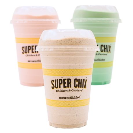 Three Super Chix custard shakes: pink, tan, and green, in clear plastic cups, with white lids and yellow bands.