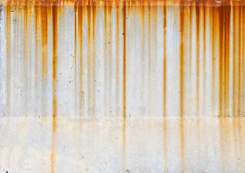 A close up of a rusty metal wall.