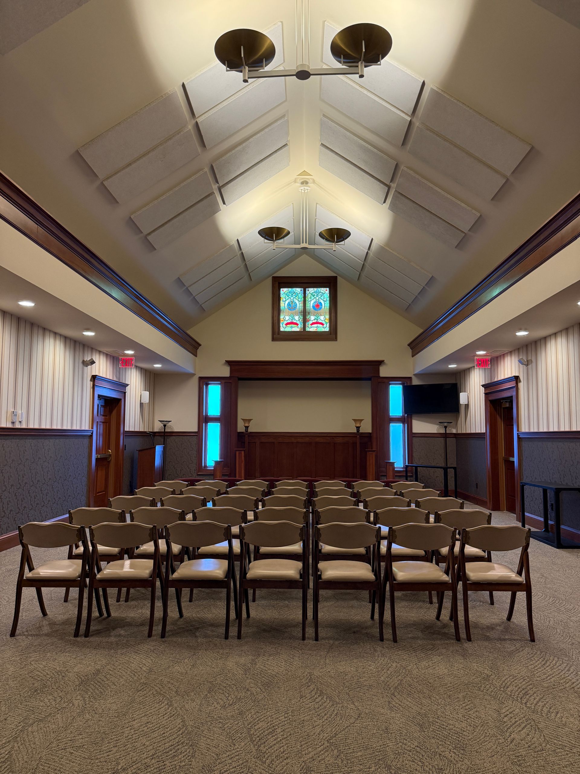 Interior chapel at Waite Funeral Homes in Medina with vaulted ceiling and stained glass