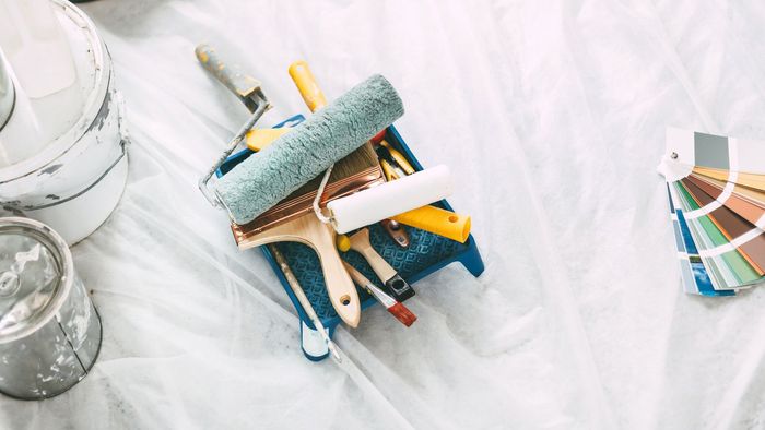 construction tools and color palette on the floor in the apartment.