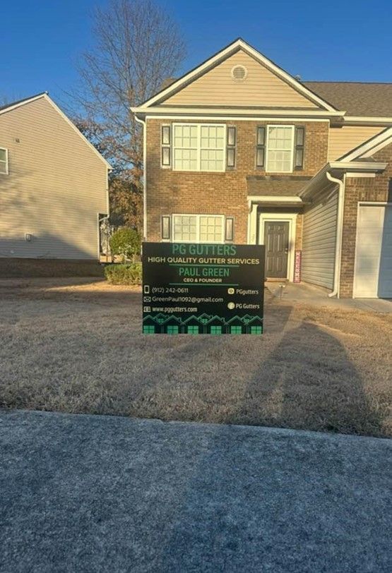 A large house with a sign in front of it.