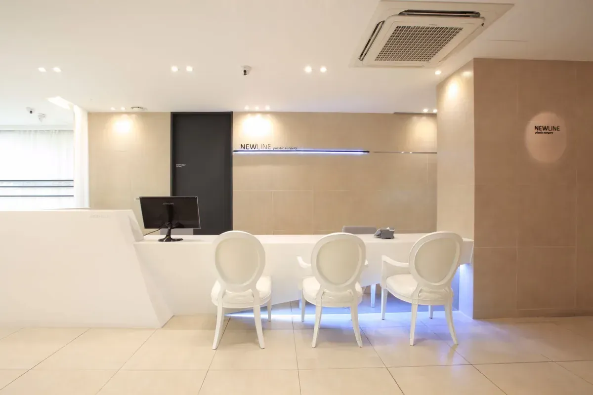 Modern spa treatment room with orange walls, two massage beds, and soft ambient lighting