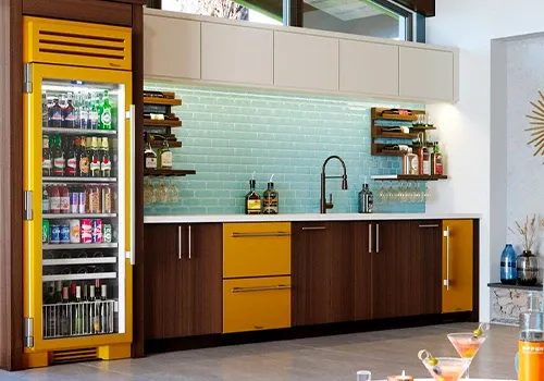 A kitchen with a commercial under-counter refrigerator and a yellow commercial refrigerator that John's Heating, Cooling, and Appliance repair provides service for in Atlanta, Ga.