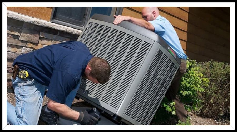 Two men are working on an air conditioner outside of a house.