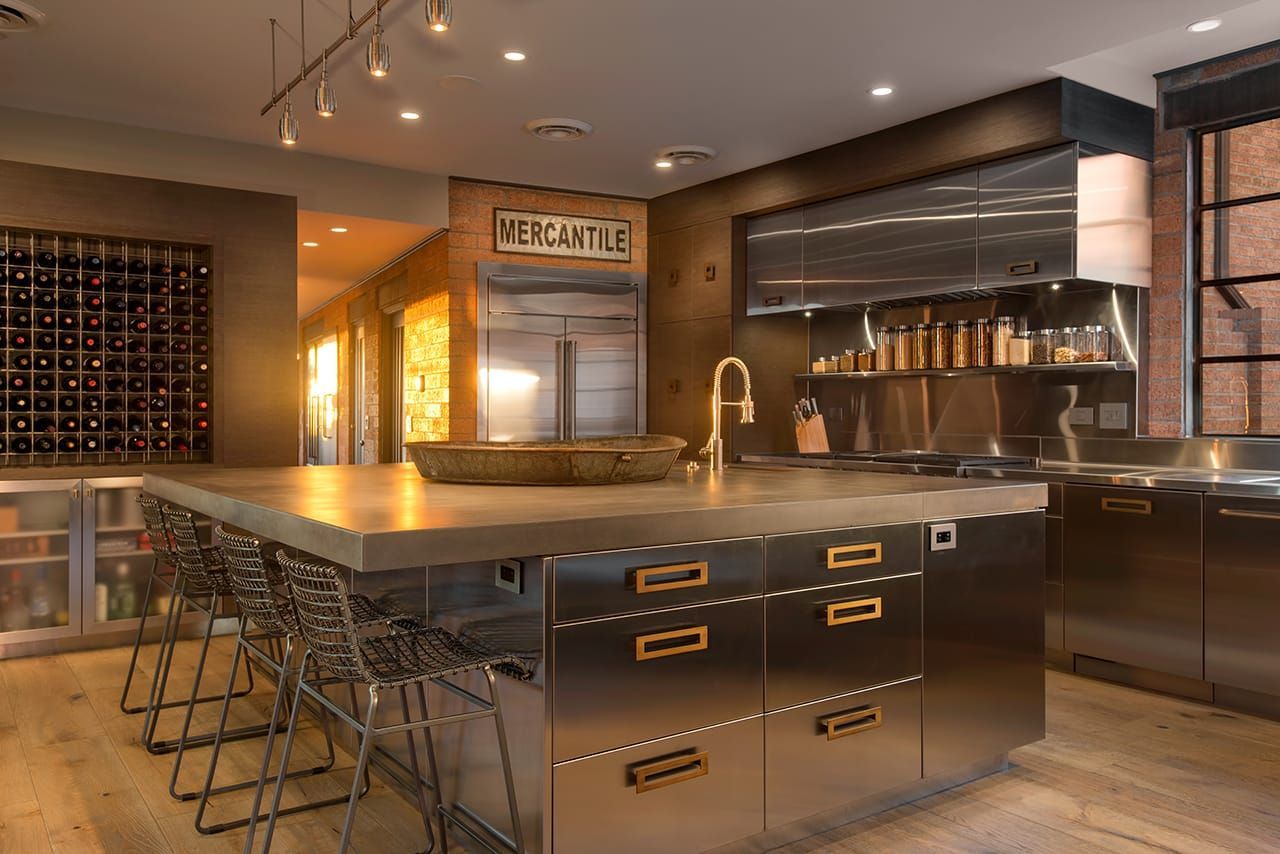 A kitchen with stainless steel cabinets and a large island.