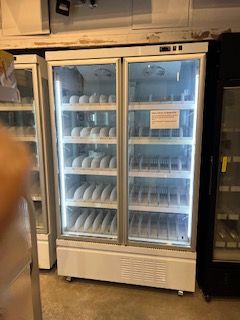 A commercial reach-in freezer is being repaired by John's Heating, Cooling, and Appliance Repair.
