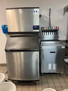 A stainless steel commercial ice machine in Fayetteville is being cleaned by John's Heating, Cooling, and Appliance Repair.
