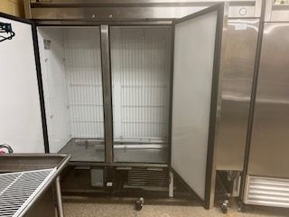 A stainless steel commercial reach-in freezer is having its doors replaced.- part of John’s Heating, Cooling, and Appliance Repair’s reliable Commercial Refrigeration Repair service for restaurants and commercial kitchens.
