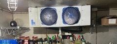 The evaporator coil with two fans is being cleaned by John's Heating, Cooling, and Appliance Repair. Bar in Atlanta Ga, part of our Commercial Refrigeration repair services
