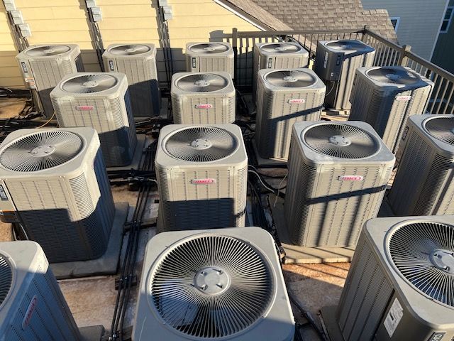 17 air conditioners that were installed by John's Heating, Cooling, and Appliance Repair
 They are sitting on top of a roof in Fayetteville ga.