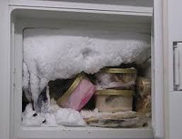 A freezer filled with ice and containers of food.
