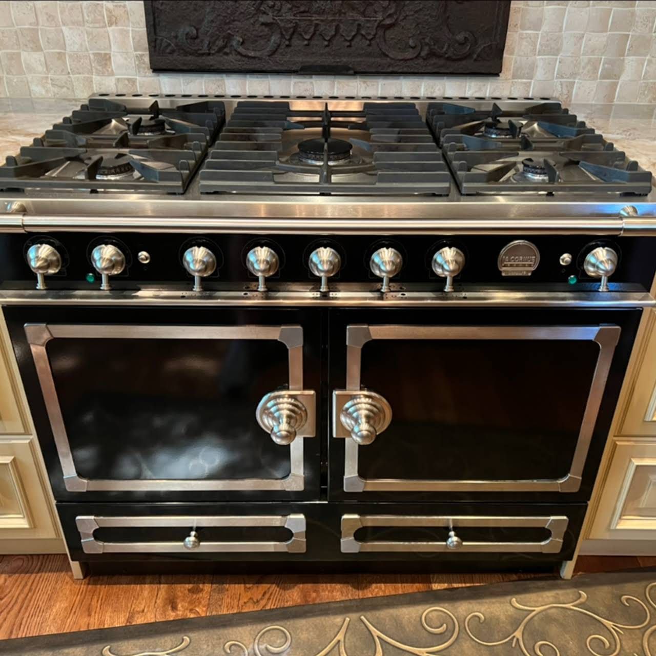 A black stove top oven with stainless steel handles