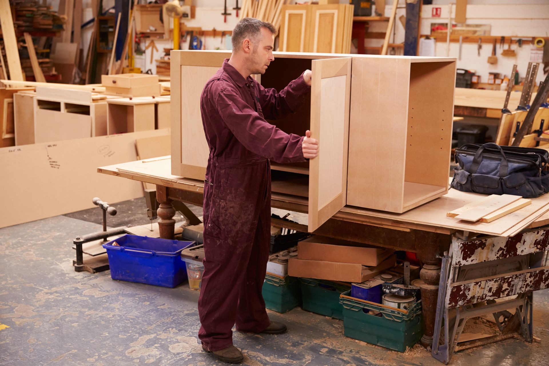 Carpenter Building Furniture In Workshop