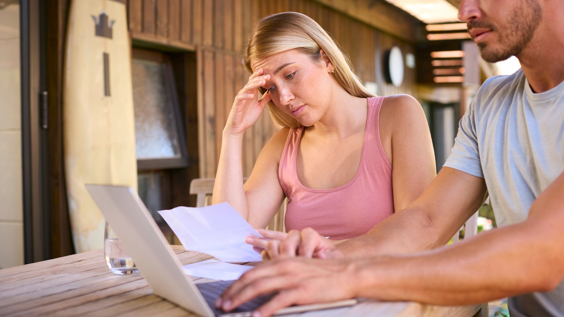 Couple reviewing rising home insurance costs and renewal paperwork at home in Missouri