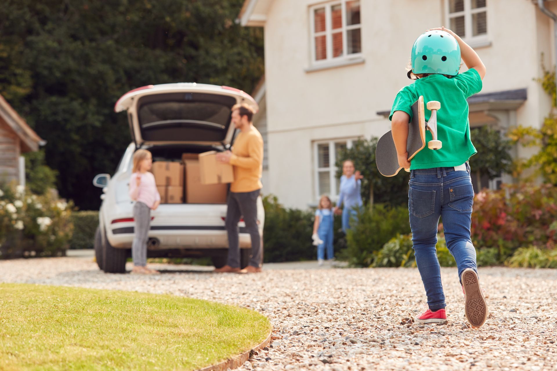 Family moving into new home unloading car on moving day