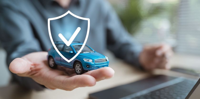 Compare car insurance rates in Springfield MO man holding blue car _ get coverage for car insurance from Geico, Travelers, and more in Springfield MO