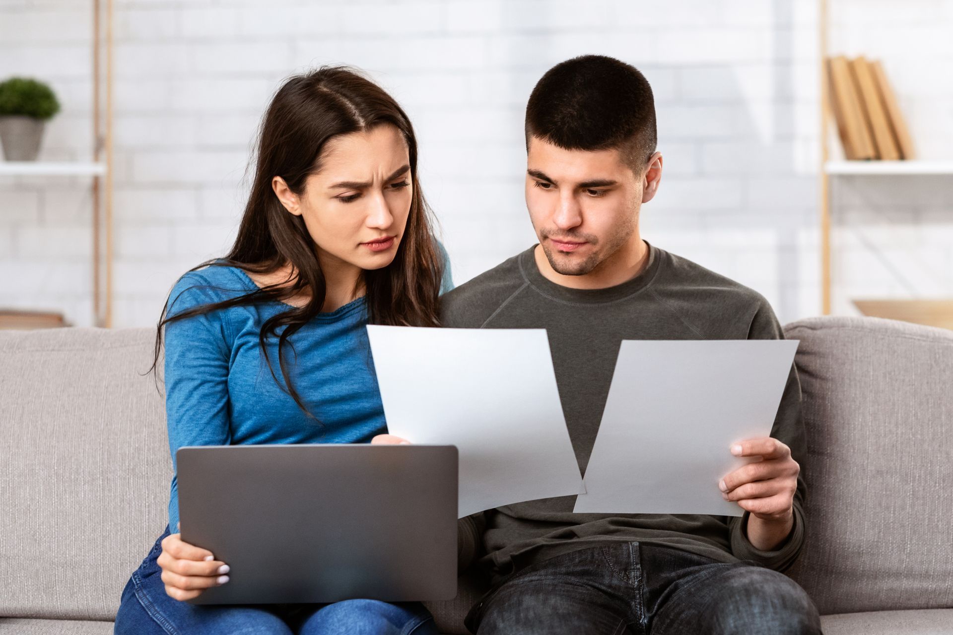 Homeowners comparing home insurance quotes and coverage options at home before choosing a policy
