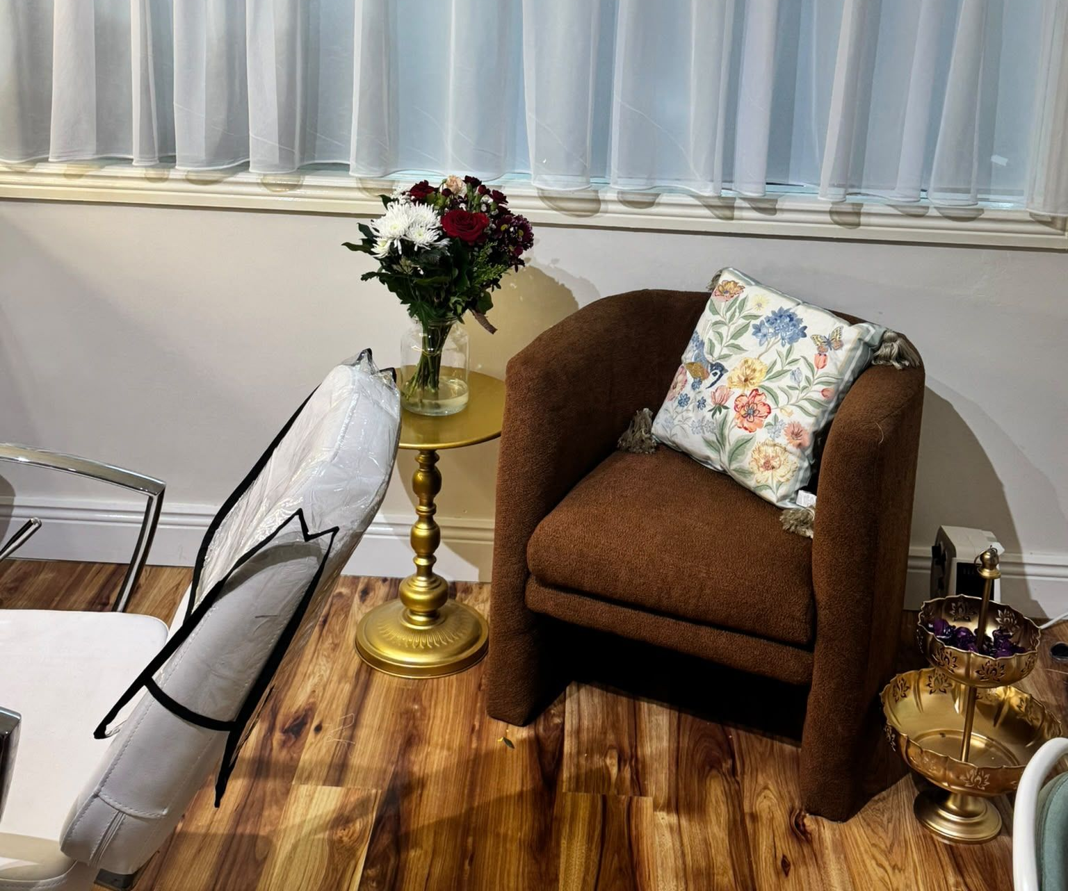 A bunch of makeup brushes in a black cup on a table.