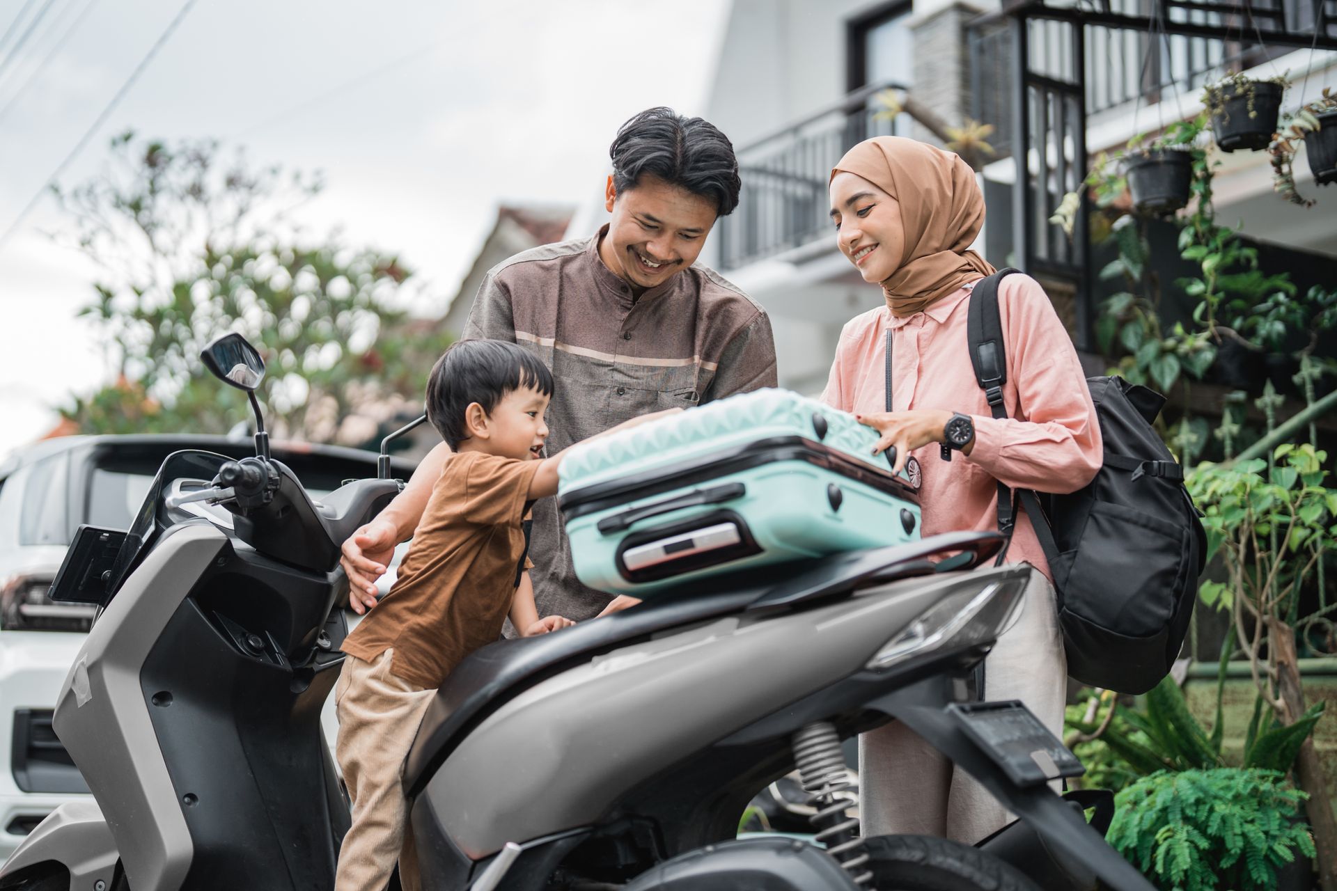 Muslim family with moped travelling together during Eid Mubarak, representing halal family holidays