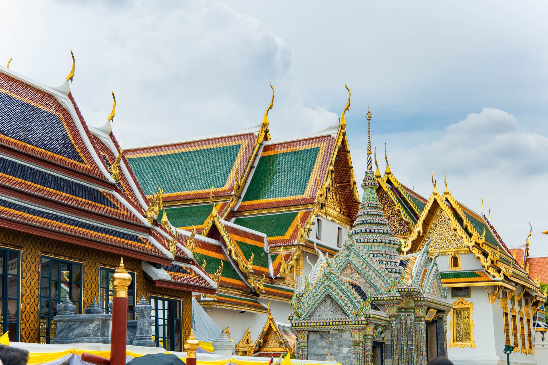 Intricate rooftops and golden spires of the Grand Palace complex in Bangkok