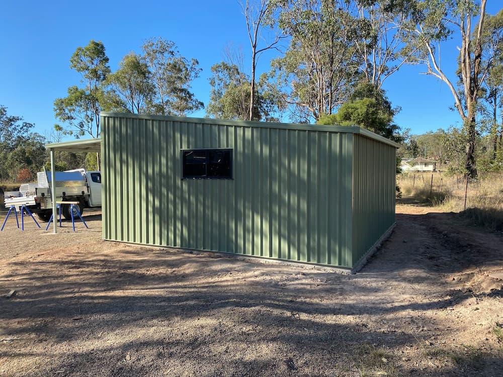 Car Parked in Green Shed - Homes And Sheds Australia Wide
