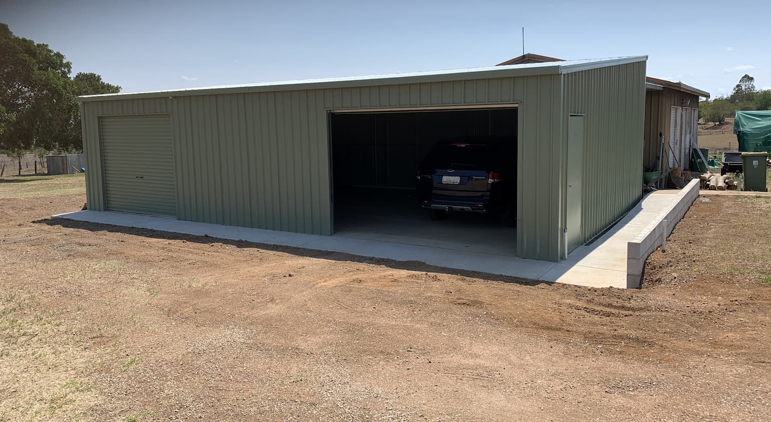 Car Parked in Green Shed - Homes And Sheds Australia Wide