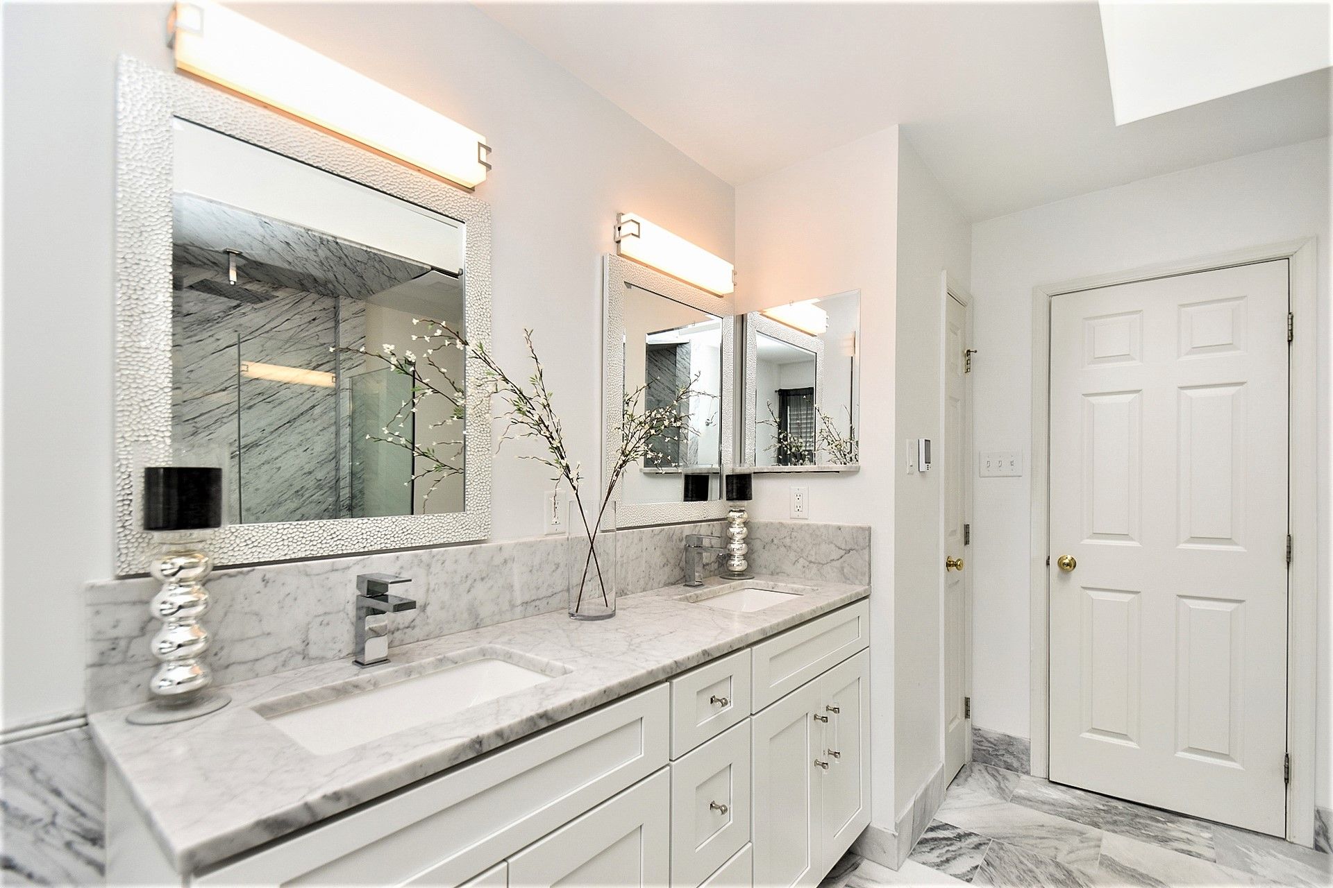 A bathroom with two sinks and two mirrors.