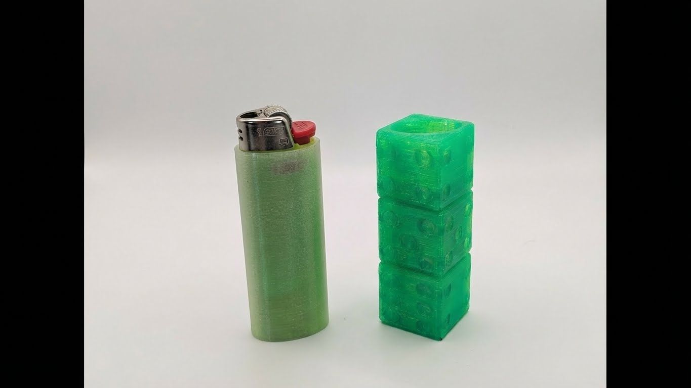 Green lighter beside a green textured rectangular object on a plain white background