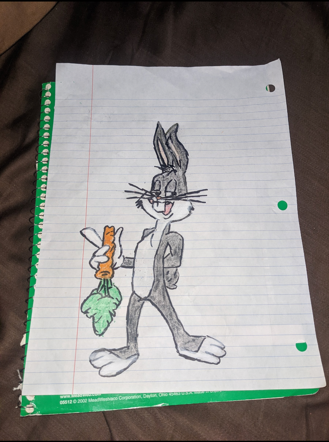 Hand-drawn Bugs Bunny holding a carrot on lined notebook paper with green binder holes
