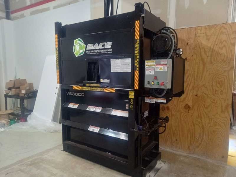Black industrial cardboard compactor.