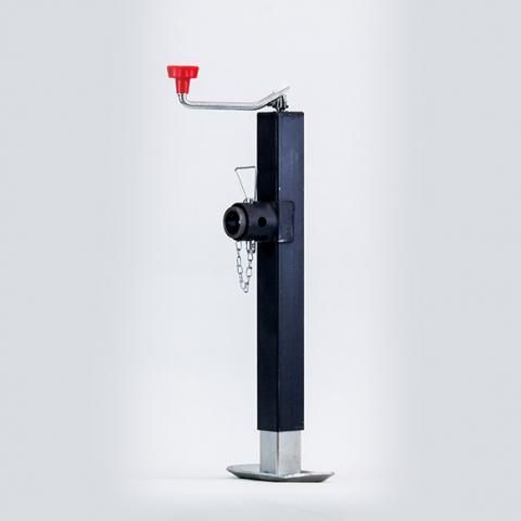 Black fire hydrant on a metal base with a red cap and side chain on a plain light background