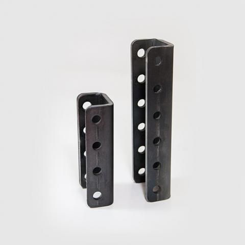 Two black metal shelf brackets with perforated holes, standing upright on a white background