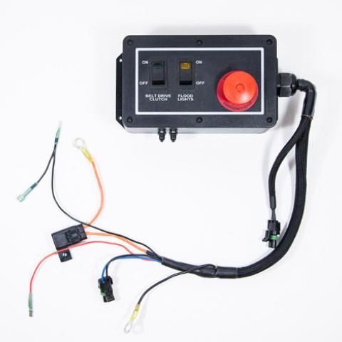 Black control box with red emergency stop button and attached wiring harness on white background