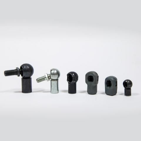Six small metal rod-end joints in black and silver, lined up on a white background.