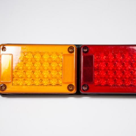 Yellow and red warning lights side by side on a white background