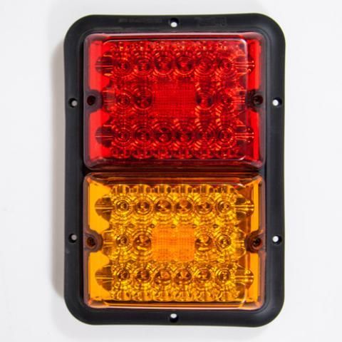 Rectangular vehicle tail light with red top lens and amber bottom lens on a black housing