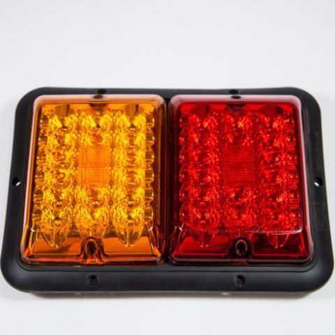 Rectangular amber and red LED vehicle tail light with black housing