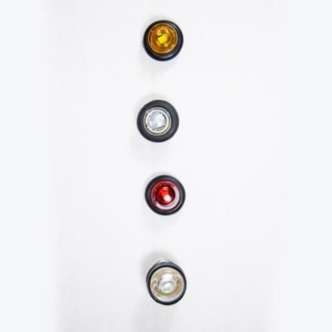 Four stacked circular lights or buttons on a white background: amber, white, red, and clear.