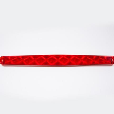 Red translucent faceted bar-shaped object on a white background