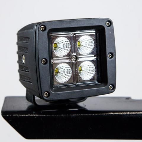 Black square LED work light with four bulbs mounted on a bracket