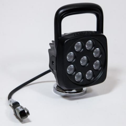 Black portable LED work light with handle and cord on a white background