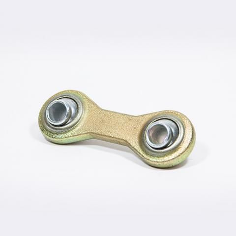 Small gold metal linkage with two silver circular joints on a white background