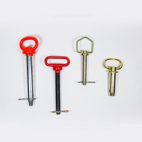 Four assorted metal screw anchors with red, gold, and silver handles on a white background