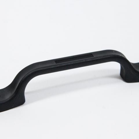 Black plastic carrying handle with vented top on a white background