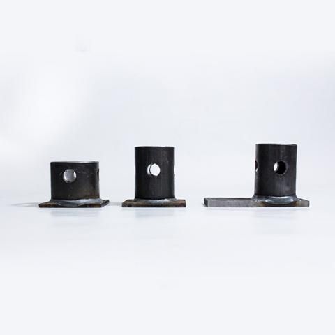 Three black metal brackets with circular holes arranged on a white background